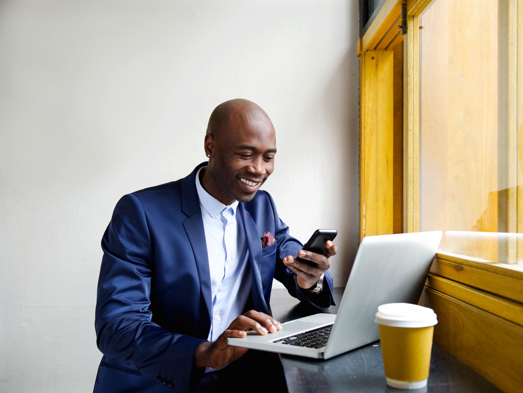 african_american_man_mobile_phone_laptop